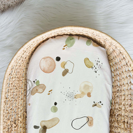 Baby bassinet cotton spandex fitted sheet with multi colours, green, brown, mustard cream background with multi colours, green, brown, mustard.
