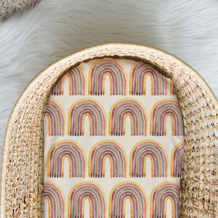 Baby bassinet fitted sheets made from spandex and cotton. Holly pattern is bright rainbows