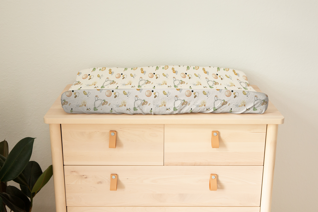 Beautiful soft bassinet sheet and change mat cover - Abstract baby design has a cream background with multi colours, green, brown, mustard.